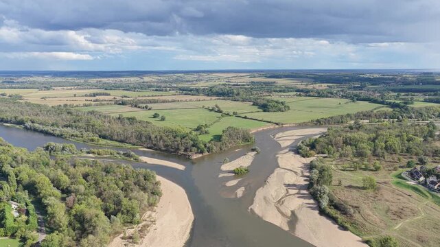 A high-angle aerial shot captures the confluence of two rivers at Bec d'Allier, France, where the Loire and Allier rivers meet.