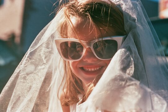 Little girl plays dress up as a bride in the 90s