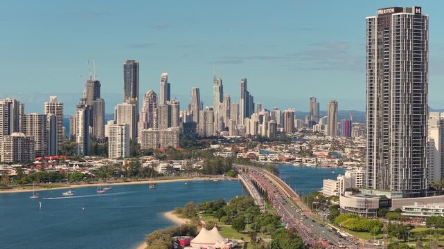 Horizontal aerial footage trucking right over Sundale Bridge, Southport and the Gold Coast Marathon with the Surfers Paradise skyline, Gold Coast, Queensland, Australia