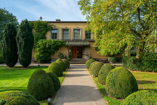 Dordrecht, Netherlands &ndash; October 19, 2025: Historic Villa Augustus surrounded by manicured topiary, mature trees, and landscaped gardens on a bright summer day, classic Dutch architecture exterior
