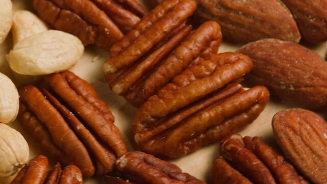 Nuts mix of pecan walnut cashew hazelnut pine and Brazil nuts with peanut on wooden table healthy snack close-up