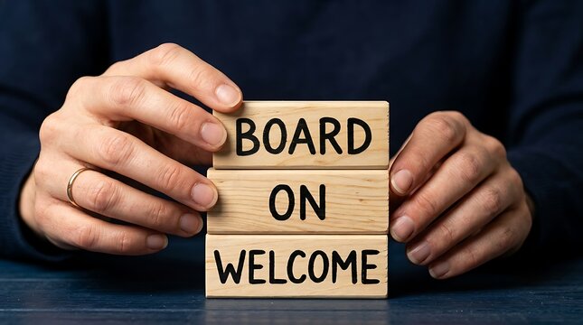 Hands stacking wooden blocks forming the welcome on board message phrase with business, resources