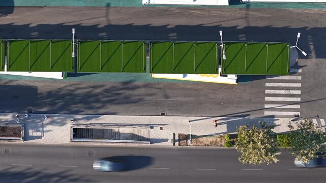 Aerial view of Cascais Bus Terminal with modern green roof shelters and parking area in Cascais, Lisboa, Portugal.
