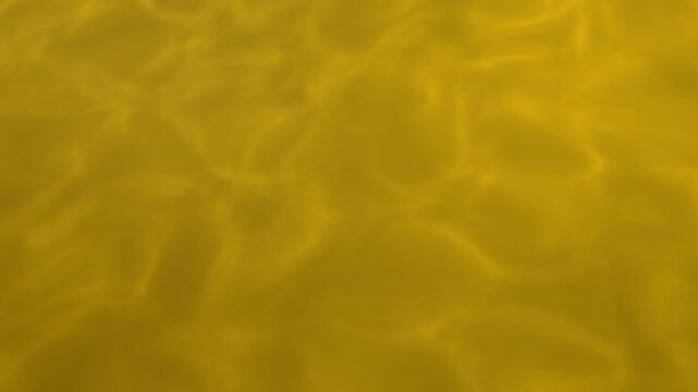 Abstract gold water ripples 4K animation video seamless looping for fluid motion background. Seamless loop of abstract gold water ripples moving in smooth fluid background 4K video.