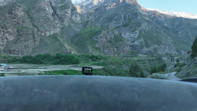 Aerial view of revealing green Himalayan valley with stepped fields and a deep gorge near Jispa Himachal Pradesh shot by a drone rising above
