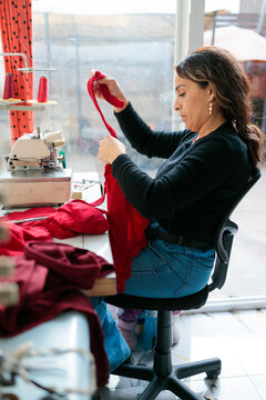 Woman holding fabric in her workshop