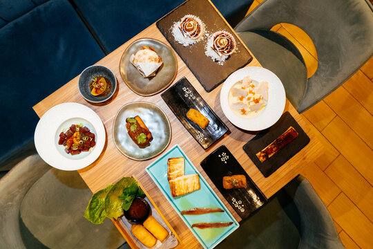 Spanish and fusion tapas sharing plates on wooden table