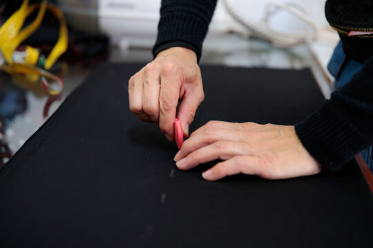 Woman drawing on textile with chalk