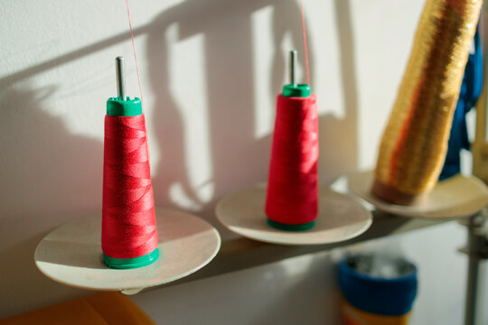 Red thread spools on stands