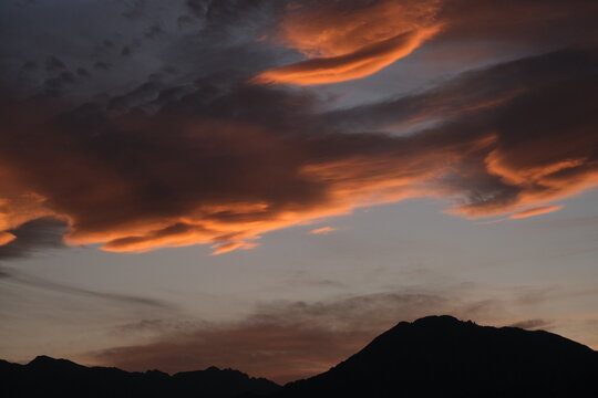 Dramatic sunset sky above alpine mountains near Lake Garda