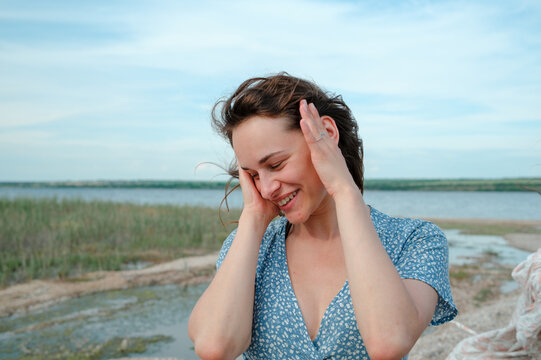Close-up portrait of a smiling woman in the wind