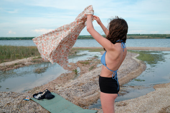 Woman getting dressed after a day by the water