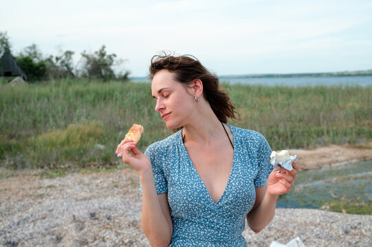 Woman enjoying a snack after a day by the water