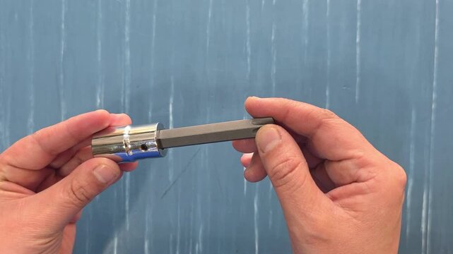 Person showing a long Torx (star-bit) socket.