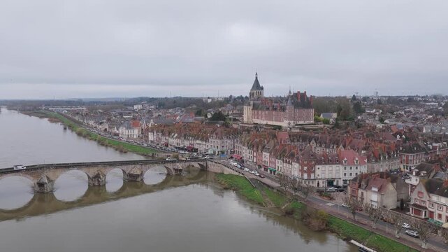 The cityscape of Gien, France, focusing on the picturesque town center along the Loire River, aerial view.