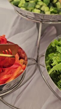 Salad preparation at an outdoor event with fresh vegetables