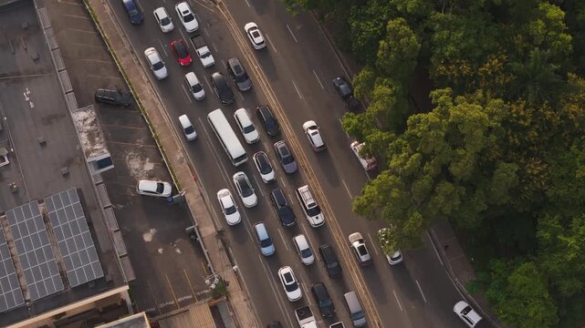 Aerial view of traffic at the Avenida de los Proceres intersection with cars moving through the yellow box junction in Santo Domingo, Distrito Nacional, Dominican Republic.
