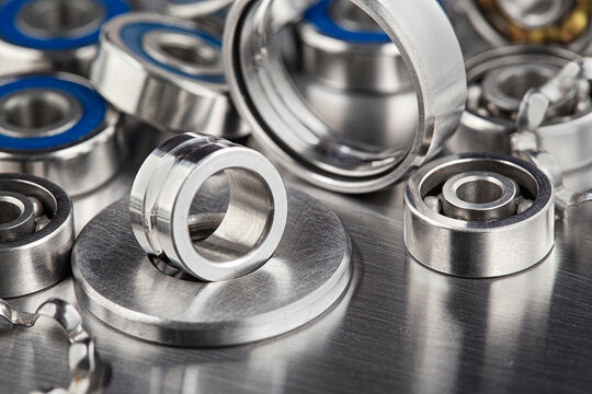 disassembled bearing on metal plate against the background of mechanism parts.
