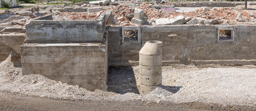 Demolished Building Foundation with Concrete Rubble at Construction Site