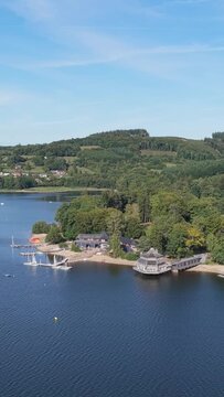 The scenic shoreline of Lac des Settons in the Morvan region, France, aerial vertical 9:16 view.