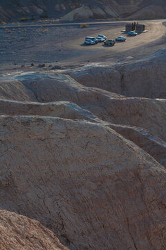 Beautiful wide view of Zabriskie Point parking lot among badlands hills in Death Valley