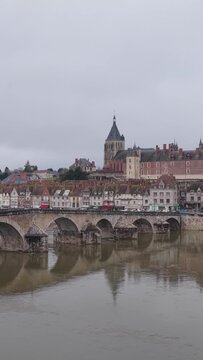 The iconic stone bridge crossing the Loire River in the center of Gien, France, vertical 9:16 view.