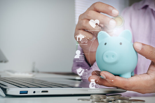 Person putting coin into blue piggy bank with financial planning holographic icons for family, retirement, and emergency fund, concept of personal finance, wealth management, and money saving.