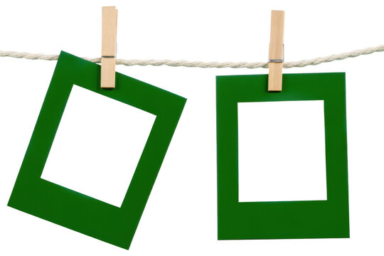 Two green empty frames hanging on a rope with wooden clothespins against a white background, for displaying your, own personal isolated on a transparent background