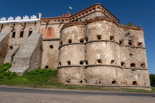 Historic Medzhybizh fortress stone bastion and decorative white battlements with Ukrainian flag