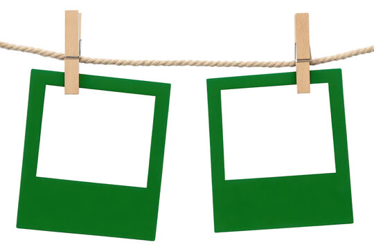 Two green empty frames hanging on a rope with wooden clothespins against a white background, for displaying your, own personal isolated on a transparent background