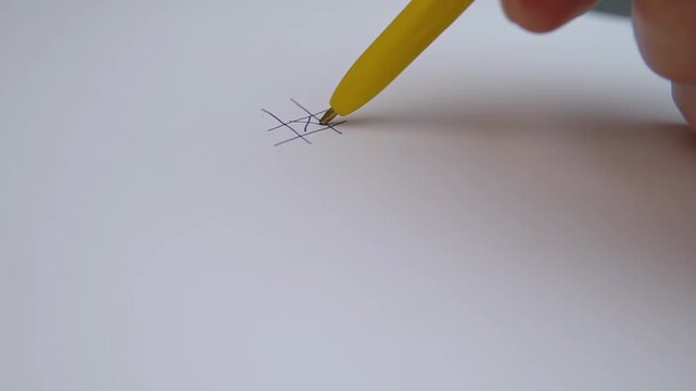 Accelerated video tic tac toe close up of playing tactical noughts and crosses strategy game in 4K Ultra HD footage.
