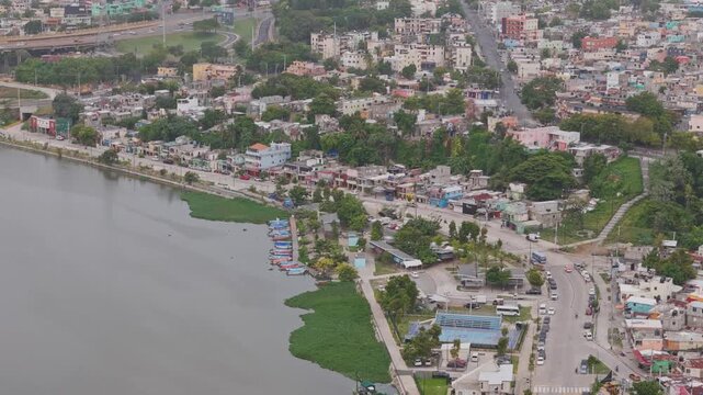 Latin American urban development and coastal community concept showing aerial view of riverbank settlements