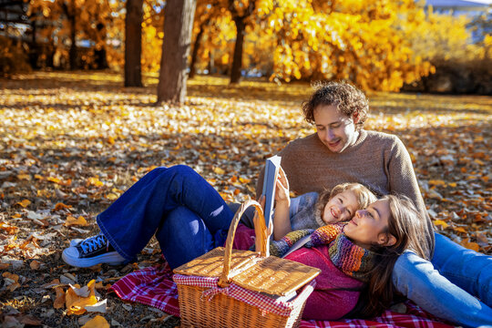 High angle view of family behind an autumn picnic basket