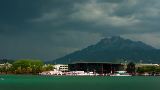 Lucerne Switzerland skyline time lapse with storm clouds moving over Lake Lucerne, KKL culture center and Mount Pilatus