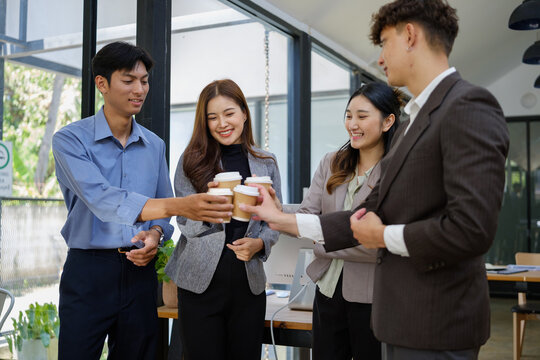 Diverse business colleagues enjoying coffee together during an office break.