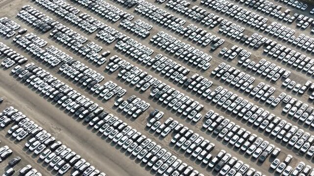 Aerial view of rows of new cars parked in a large distribution lot in Chennai, Tamil Nadu, India.