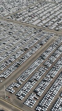 Aerial view of rows of new cars parked in a large storage lot in Chennai, Tamil Nadu, India.
