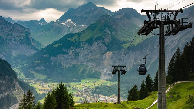 Dramatic stormy timelapse of Oeschinen cable car lift towers overlooking Kandersteg alpine valley with rushing clouds in Swiss Alps