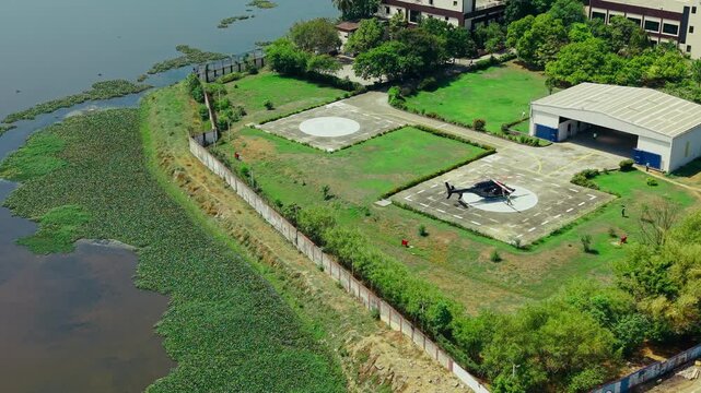 Aerial view of a helicopter parked on a helipad near a water body in Sholinganallur, Chennai, Tamil Nadu, India.