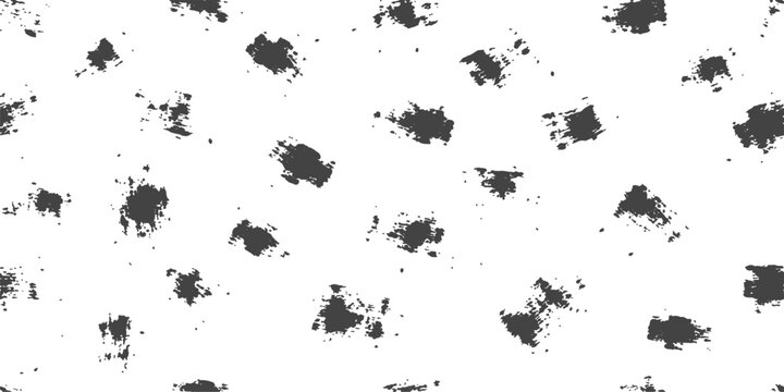 Abstract black ink splatters and brush strokes on a white background creating a dynamic organic pattern for design