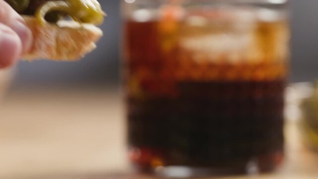Gilda pintxo, traditional Spanish tapas with hot green pepper, anchovy, olives and pickled vegetables, served with vermouth