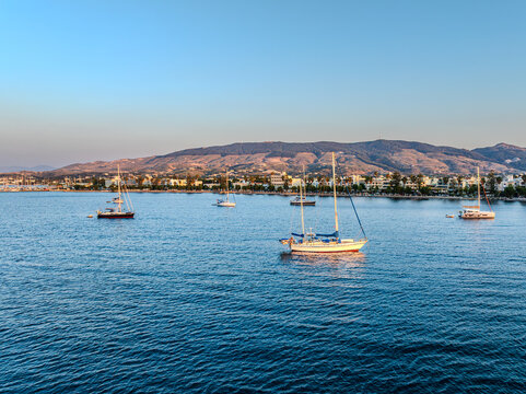 Sailboats anchored off Kos Town with Dikeos mountains, Greece