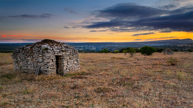 Traditional dry stone shepherd hut shelter in rural landscape during sunset at Orbaneja del Castillo in Burgos Spain