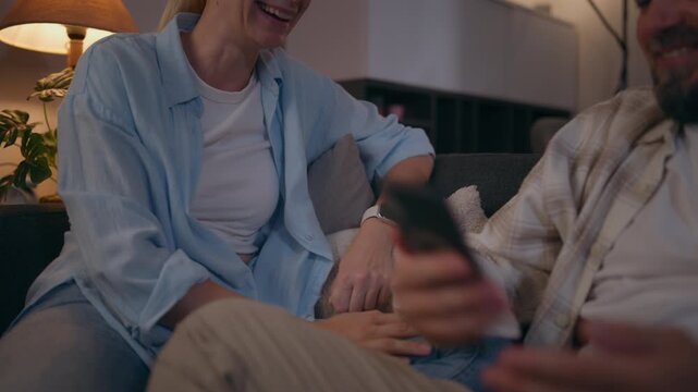 Couple discussing a disagreement at home before ending the conversation with shared laughter, illustrating conflict resolution, compromise, empathy and positive relationship dynamics.