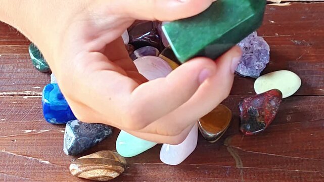 Natural minerals in hand. Semi-precious multi-colored stones, minerals close-up. Mineralogy. Collection of minerals.	