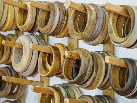 Wooden hat blocks for hat making mounted on holders.