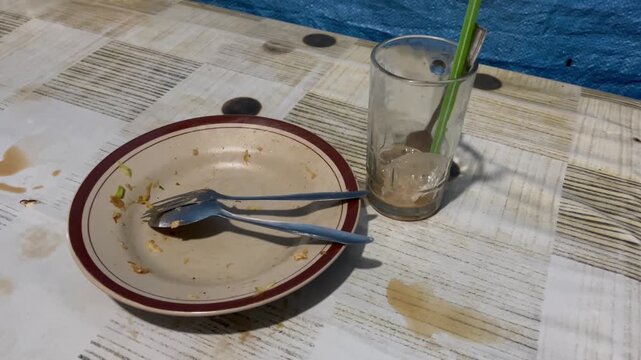 Dirty dishes and empty drink glass after dining