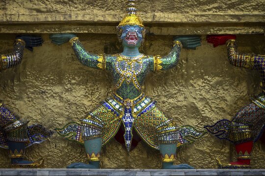 A row of giants supporting a chedi (all the giants surrounding the chedi are figures from the Ramakien), Wat Phra Kaeo (Temple of the Emerald Buddha), Grand Palace, Bangkok, Thailand
