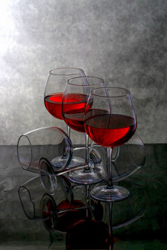 Still life with glasses and red wine against a dark background