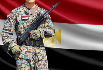 Fototapeta premium Egypt flag with soldier holding assault rifle